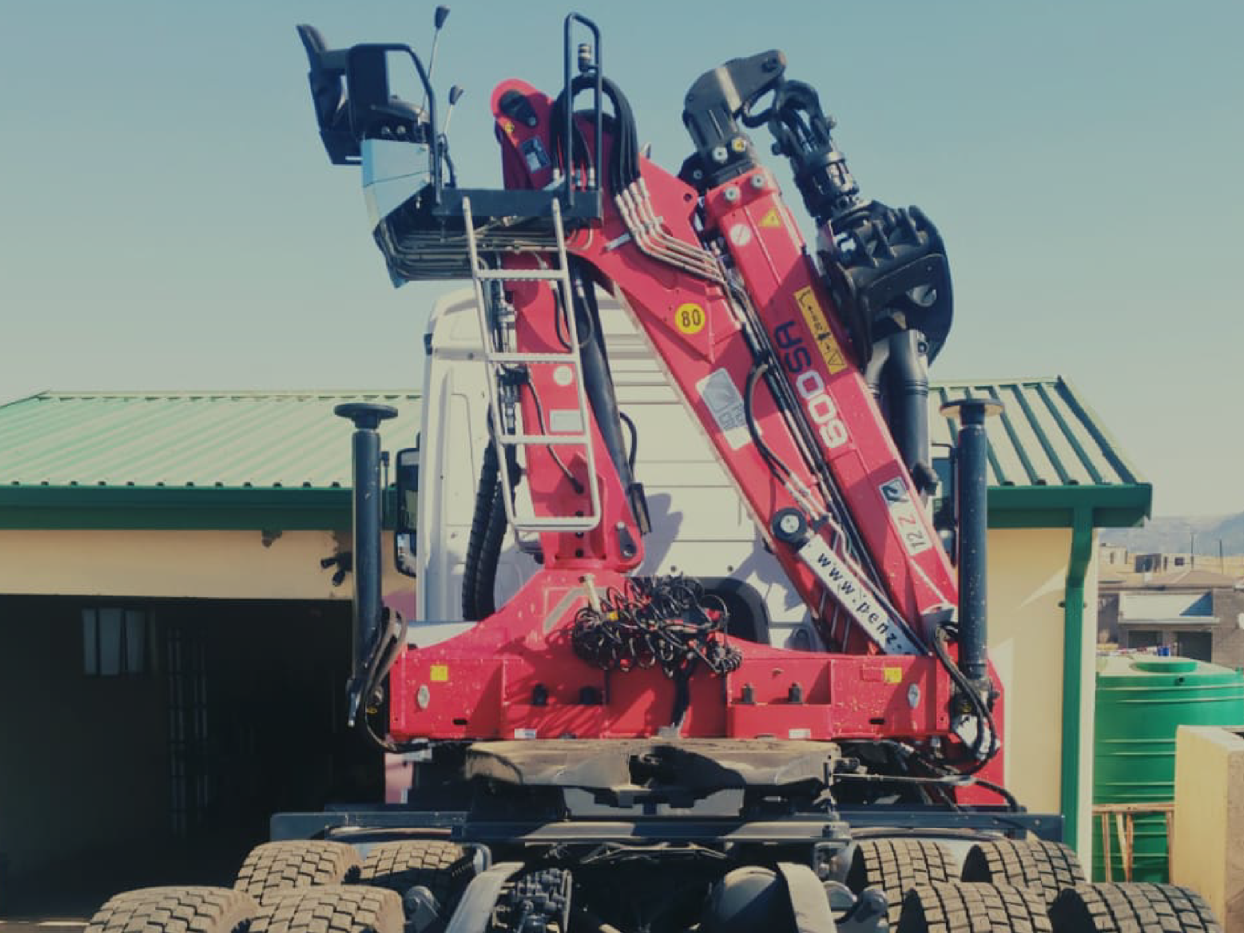 Crane-assisted delivery vehicle